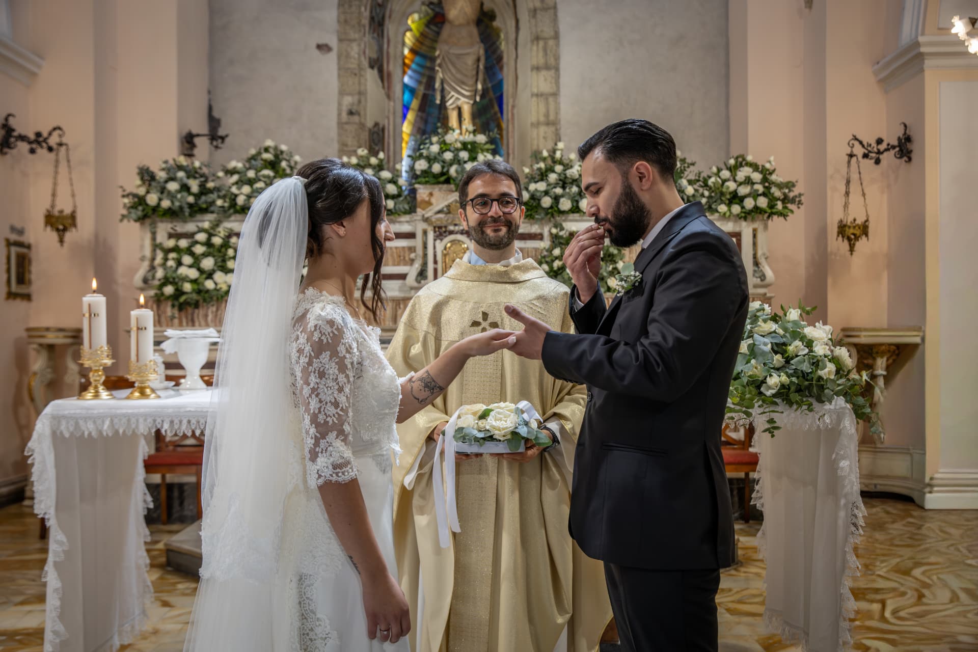 Bride and groom exchanging rings during their church ceremony
